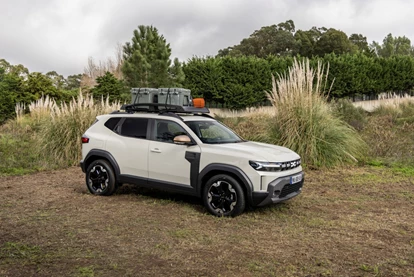 Third-Generation Dacia Duster with trees in background.