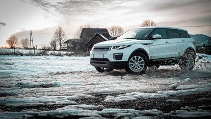 Range Rover driving through snow and icy conditions.