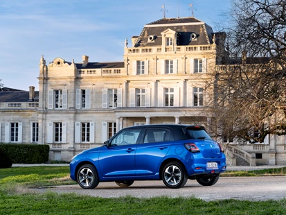 Suzuki swift in front of a building